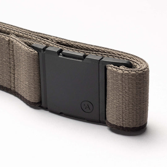 A close-up of the Arcade Belts Blackwood, a tan fabric belt with a sleek A2 buckle, shown against a plain white background—ready to explore new styles.