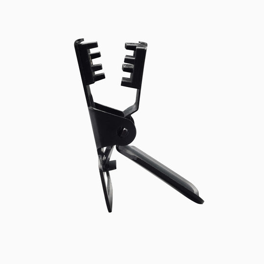 The Arcade Belts Jessup is a black plastic clamp with a handle and notched gripping jaws, ideal for adjusting Arcade Belts or securing stretch webbing on a low-profile belt. Shown against a plain white background.
