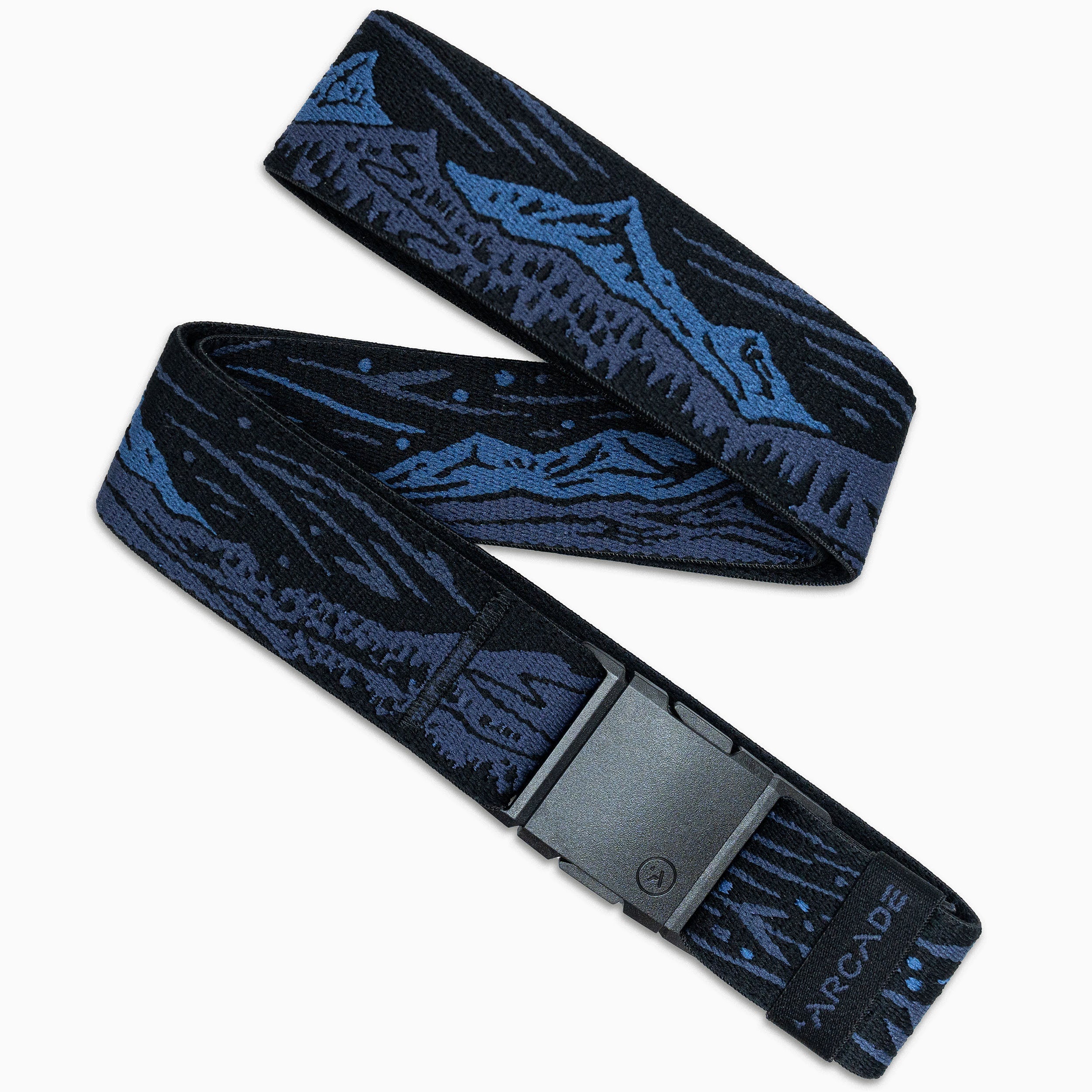 The Arcade Belts Out of Range is a dark blue and black belt with a mountain landscape design, made from stretch webbing for comfort. It features a black plastic buckle and the Arcade logo near the buckle, laid out in a zigzag pattern.